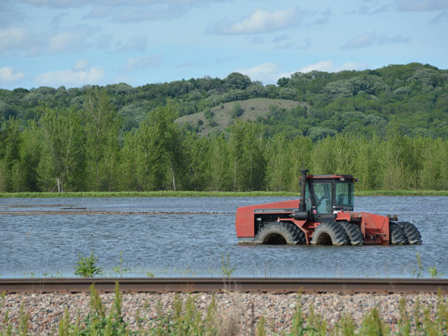A tractor remains flooded along the Missouri River just north of Hamburg, Iowa. The town has been battling floods for more than two months and water began rising again last week on the river, halting some recovery efforts. (DTN photo by Chris Clayton)